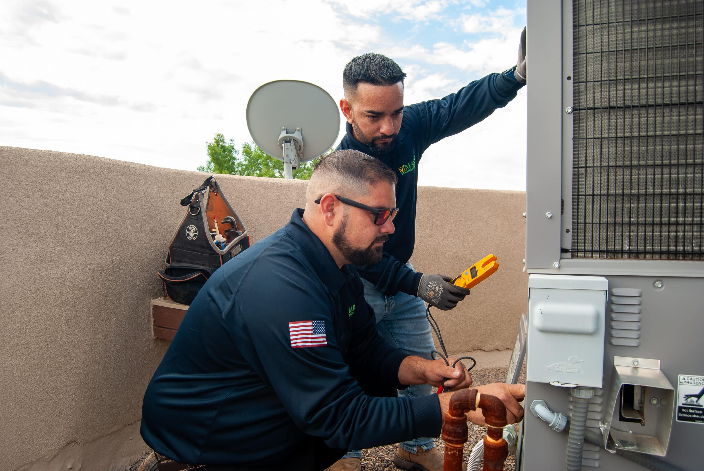 Photo of air conditioning compressor unit and people enjoying cool air conditioning